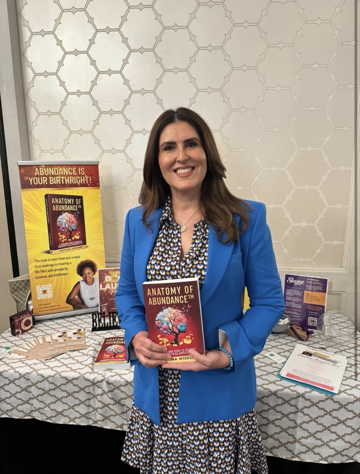 Priscilla Kashani with Anatomy of Abundance book